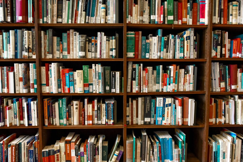 pexels-photo-1370295-1370295 Vibrant library scene featuring wooden bookshelves filled with various books.