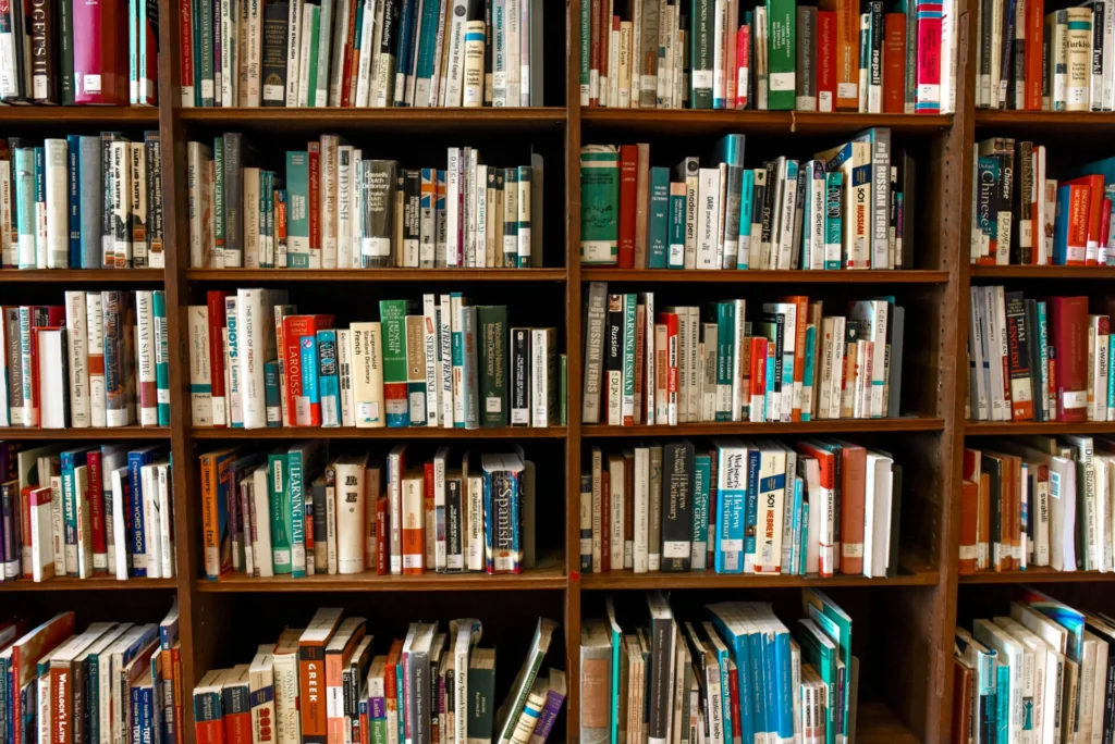 pexels-photo-1370295-1370295 Vibrant library scene featuring wooden bookshelves filled with various books.