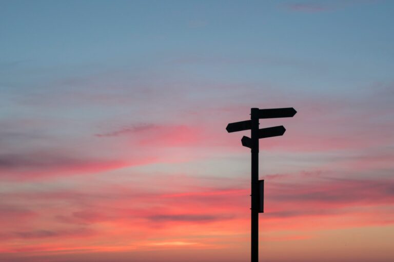 Signage on a road showing streets and their directions. This image represents the customer journey on a website.