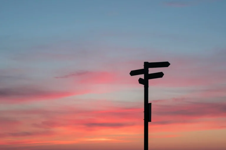 Signage on a road showing streets and their directions. This image represents the customer journey on a website.