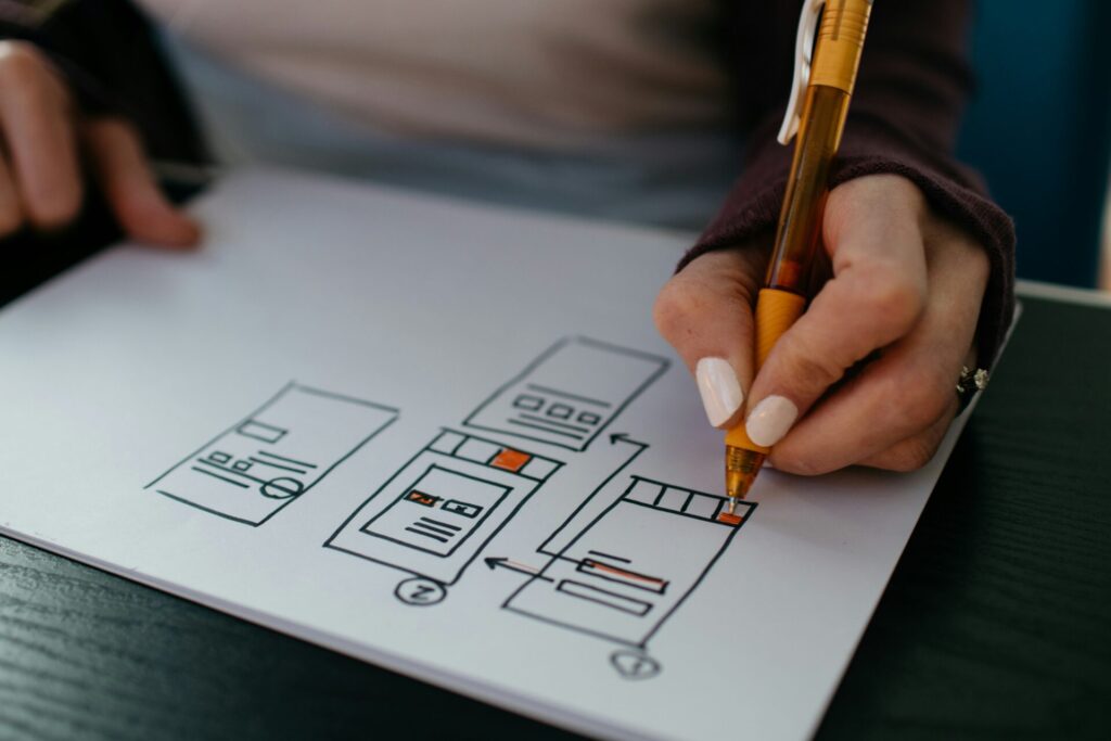 Low-fidelity wireframes A UX designer sketching out wireframes on a sheet of paper